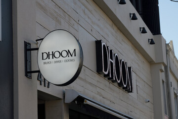 Naklejka premium wall mounted projecting sign outside DHOOM Modern Indian Bar & Kitchen, an Indian restaurant, located at 417 Danforth Av, Toronto