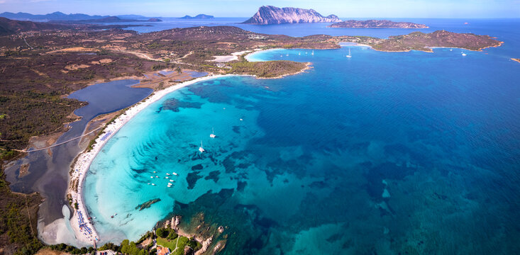 Sardinia Cala Brandinchi and Lu Impostu drone panorama with Tavolara island. Scenic turquoise bay and salt lakes. San Teodoro Italy travel wall art 8K