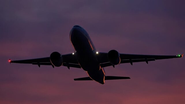 Airplane Flying High in Sunset Sky.