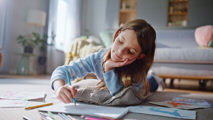 Dreamy girl drawing home floor closeup. Relaxed preteen child creating picture