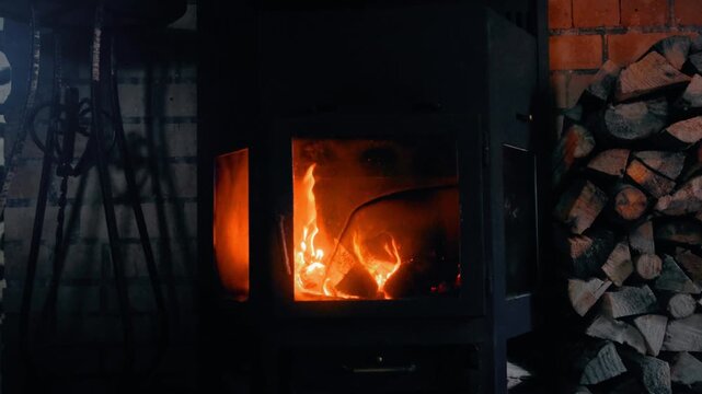 Cozy Fireplace with Burning Logs and Firewood Stack