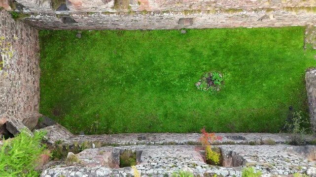 Aerial Cinematic View of Ruined Medieval Rait Castle in Nairn Scotland, Scenic Highland Landscape 