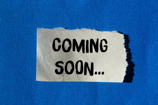 Coming soon message written on ripped torn paper background. Conceptual Coming soon symbol. Copy space.