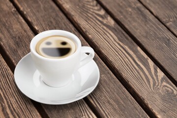 smile face in coffee cup on the desk