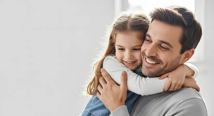 Fototapeta premium A happy father embracing his little girl in a bright and airy room with a warm smile