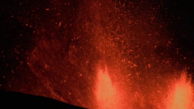 Close up view of a violent volcanic eruption with hot magma, smoke, and ashes spewing into the air