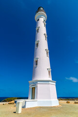 A view looking up at the California Lighthouse on the northwestern Atlantic coast of Aruba on a bright sunny day