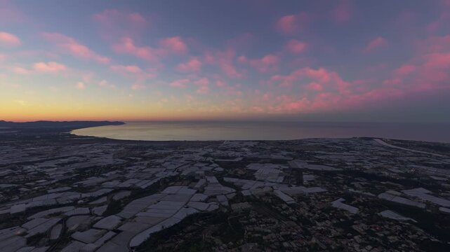 Circular aerial shot at sunset of Andalucia. Almeria. Viator. Sierra de Aracena. Greenhouse. Spain