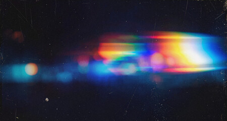 Abstract dark grunge background with rainbow lens flare light streak and bokeh overlay