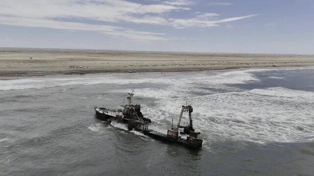 Drone descends on Zeila Shipwreck on the Skeleton Coast in the desert in Namibia