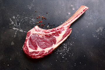 Raw organic tomahawk beef steak . Top view with copy space.