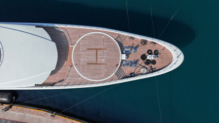 Aerial drone top down photo of luxury yacht with wooden deck and helipad anchored in tropical exotic island port © aerial-drone