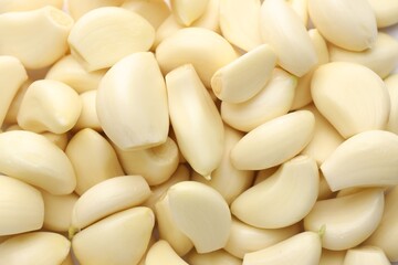 Fresh peeled garlic cloves as background, closeup