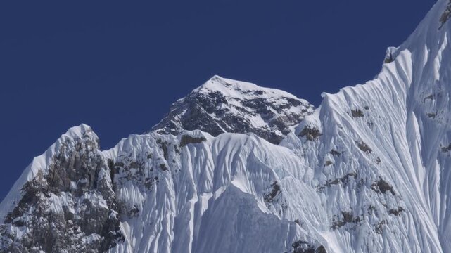 Iconic Mount Everest summit gleaming under clear blue sky in Himalayas, Nepal