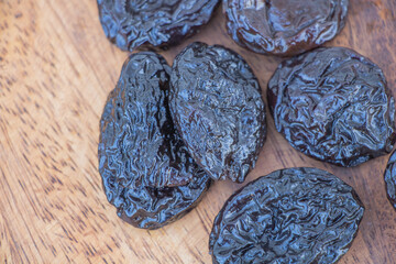 Dried Prunes Close Up on Wooden Surface - Healthy Natural Snack