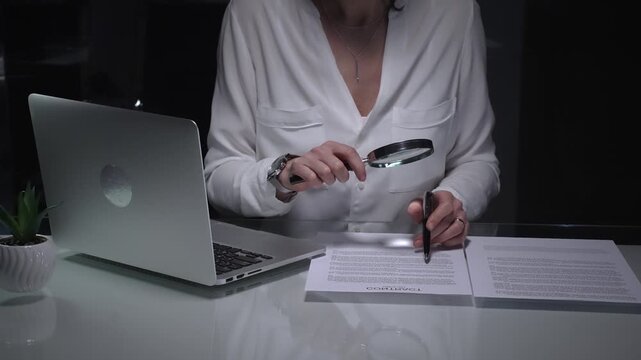 Woman analyzing contract text with magnifying glass, scrutinizing fine print for legal details and agreement review. Audit, business and overworking concepts