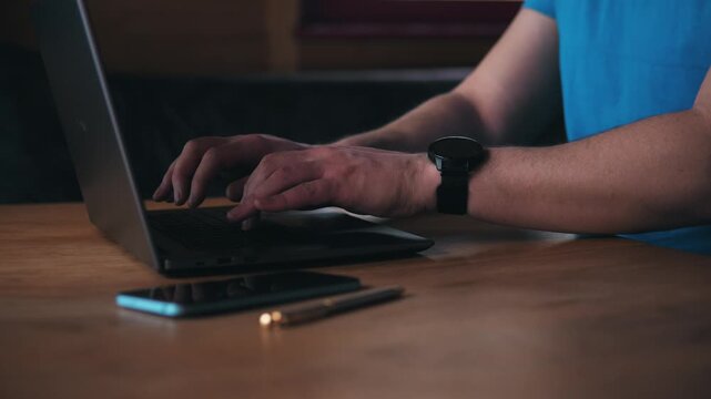 Man Working Creatively. Man In Blue Shirt Engaged In Graphic Interface Layout Work. Caucasian Man In Casual Attire Concentrating On Creative Computer Editing And Interface Arrangement