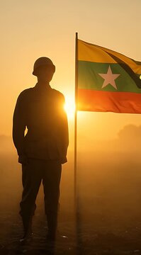 Silhouette of Soldier with Myanmar Flag at Sunrise