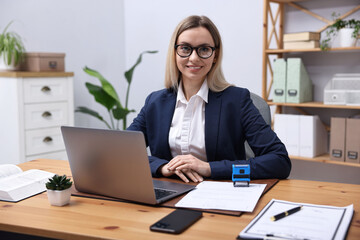 Portrait of notary at wooden desk in office
