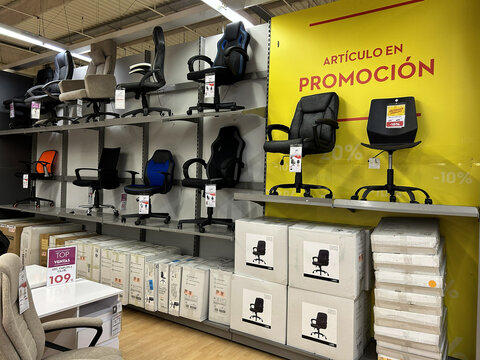 Pamplona, ​​Spain - February 28, 2026. A Conforama furniture store. Various office chairs and gaming chairs are displayed on shelves arranged at different levels. 