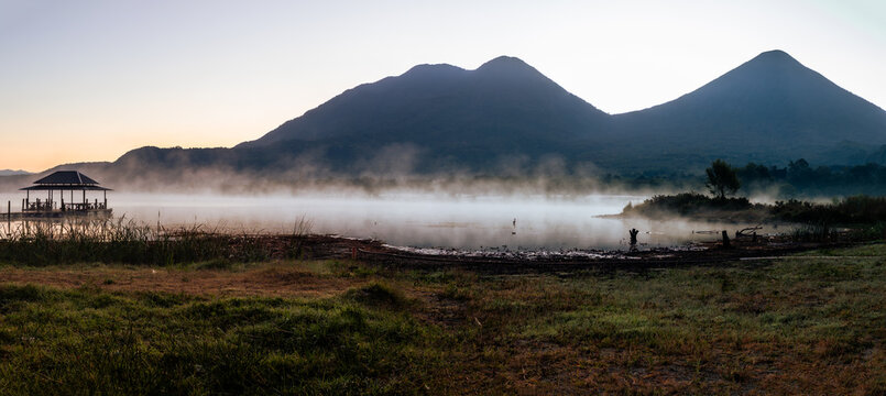 Atitlan lake with fog or mist at sunset with volcanos toliman and atitlan in the background. Tranquility and idyllic atmosphere perfect for relaxation