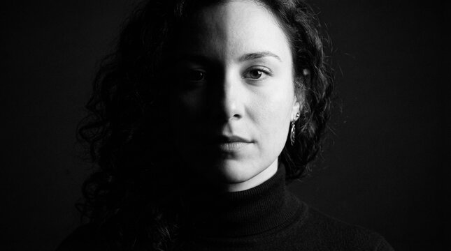 Dramatic Black and White Portrait of a Woman with Stark Light and Shadow Contrast