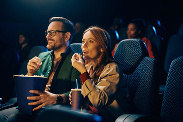 Happy couple enjoying in movie night at cinema. © Drazen