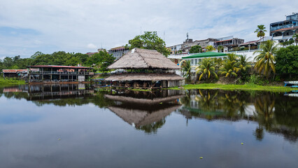 Obraz premium Panoramic aerial drone view of the riverfront boulevard of Iquitos along the Río Amazonas in the Peruvian Amazon, tropical city surrounded by rainforest and rivers, gateway for travel and tourism