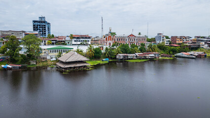 Obraz premium Panoramic aerial drone view of the riverfront boulevard of Iquitos along the Río Amazonas in the Peruvian Amazon, tropical city surrounded by rainforest and rivers, gateway for travel and tourism