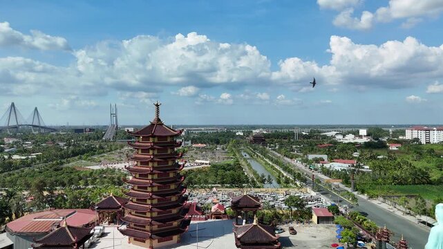 Jade Buddha Pagoda, Vinh Long, Vietnam &ndash; 4K aerial drone view of Buddhist temple complex with multi-tier pagoda tower and Guanyin statue in the Mekong Delta