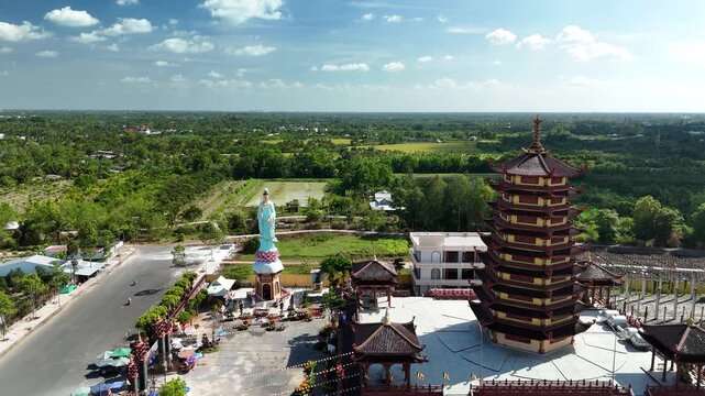 Jade Buddha Pagoda, Vinh Long, Vietnam &ndash; 4K aerial drone view of Buddhist temple complex with multi-tier pagoda tower and Guanyin statue in the Mekong Delta