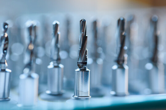 Full set of dental implant drill bits in surgical tray, close-up of professional dentistry equipment