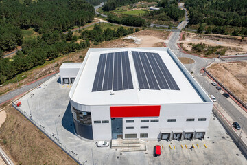 Modern warehouse building with solar energy panels on roof © Azulblue