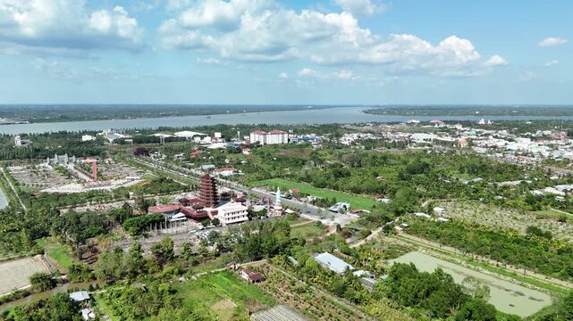 Jade Buddha Pagoda, Vinh Long, Vietnam &ndash; 4K aerial drone view of Buddhist temple complex surrounded by tropical fruit farms, rural houses, Mekong River in the Mekong Delta