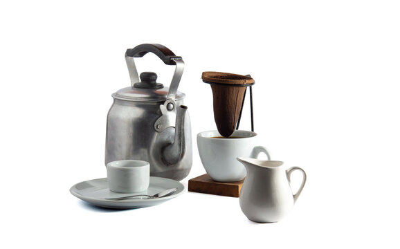 Traditional Brazilian drip coffee set with cloth filter, aluminum kettle and coffee with milk