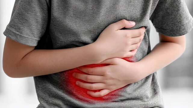 A young boy clutching his belly, showing severe abdominal pain and discomfort with a red glow.
