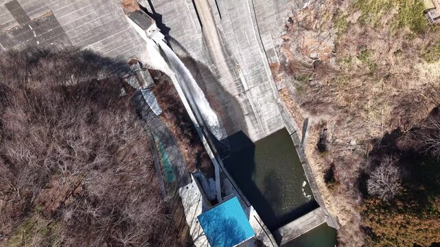 Drone footage of mountain reservoir and forest in March, Kirizumi Dam Japan