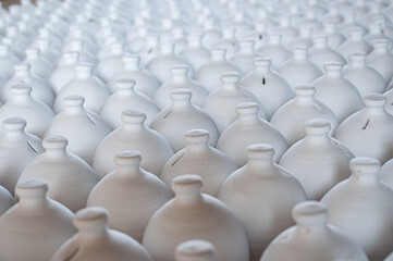Obraz premium Bahrain’s traditional A’ali hand-crafted pottery. Collection of white jugs ready for the kiln.