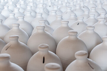 Fototapeta premium Bahrain’s traditional A’ali hand-crafted pottery. Close up of white clay jugs.