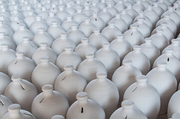 Fototapeta premium Bahrain’s traditional A’ali hand-crafted pottery. White clay jugs drying.