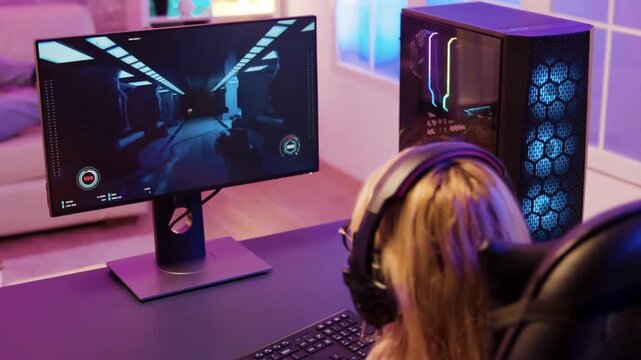 Happy Gamer Playing Shooter Game in Neon Lit Gaming Room