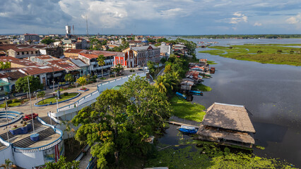 Panoramic aerial drone view of the riverfront boulevard of Iquitos along the Río Amazonas in the Peruvian Amazon, tropical waterfront surrounded by rainforest, popular destination for travel