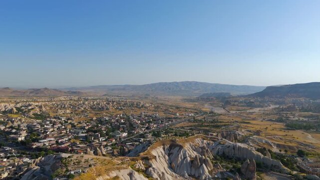 Goreme, Nevsehir, Turkey. Surreal aerial perspective of Rocket Valley's dramatic stone pillars rising like natural monuments in the Cappadocian landscape.. Aerial View, MasterShots, Tilt up, Tilt dow