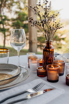 Table set for dinner on a patio at a getaway cabin.