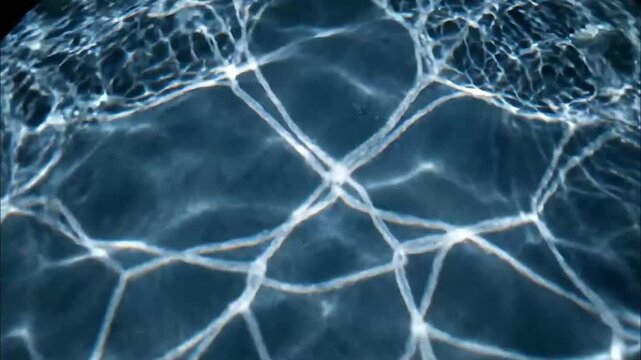 Realistic rippling water caustic light patterns reflecting onto a surface below 4K Videos