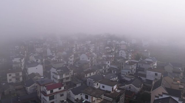 A house in rural China in the early morning fog