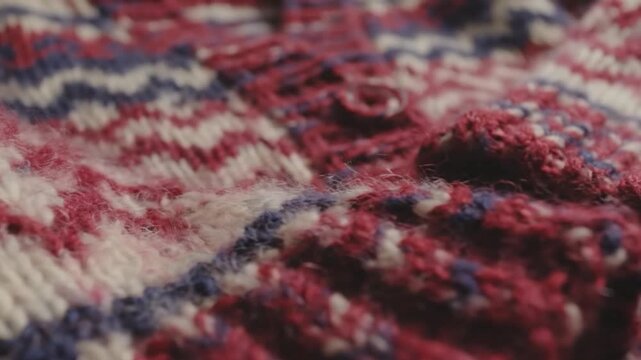 Close-up of a colorful knitted sweater fabric with intricate patterns