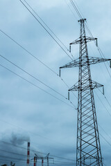 A tall power tower is surrounded by power lines
