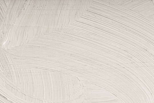 Fine texture of light coloured paint applied with a brush