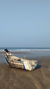Close-up of Traditional Rustic Wooden Fishing Boat on Sandy Beach Shore at cox's bazar